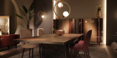 A dining room area with luxurious light fixtures. The lights are dimmed, and the space is decorated with gold accents.