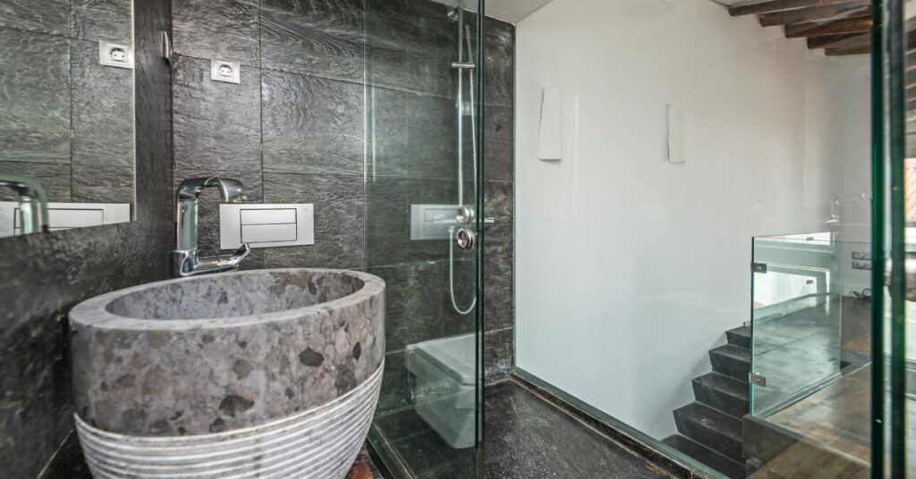 A modern bathroom with porcelain materials in various places, including the tub, shower tiles, and flooring.