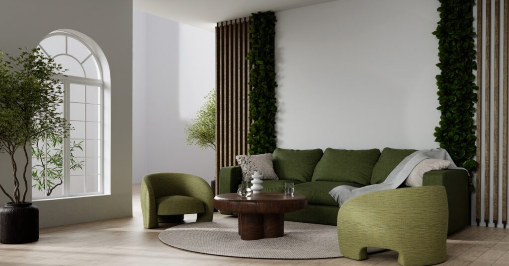 A modern living room area with neutral tones everywhere, except the dark green couch and accent chair.