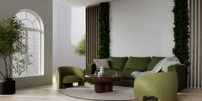 A modern living room area with neutral tones everywhere, except the dark green couch and accent chair.