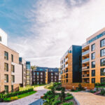 A collection of luxury apartment buildings, each with its own unique style, sharing a common courtyard and walkways.