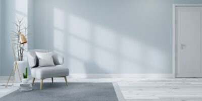 Sunlight shining through a window in a living room. The living room has light blue walls and a small light blue chair.