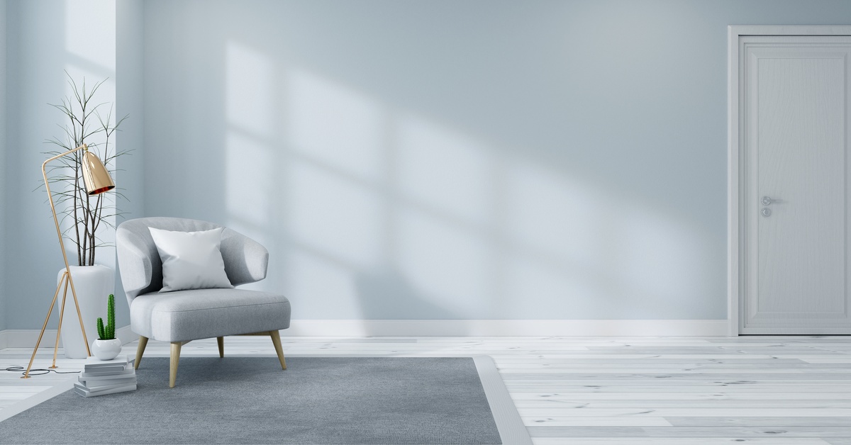 Sunlight shining through a window in a living room. The living room has light blue walls and a small light blue chair.