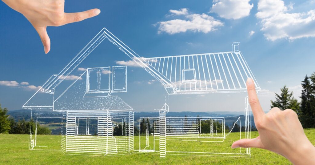 A point of view of looking at an empty grass lot with hands framing a 3D graphic of a home design sketch.