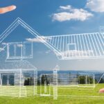 10 Things Not To Overlook When Designing a New Custom Home A point of view of looking at an empty grass lot with hands framing a 3D graphic of a home design sketch.
